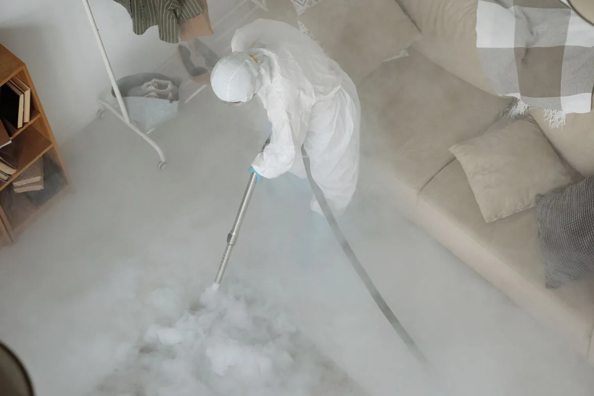 Biohazard cleanup technician in protective equipment, Loving, NM